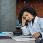 An Exhausted Woman Reading Documents